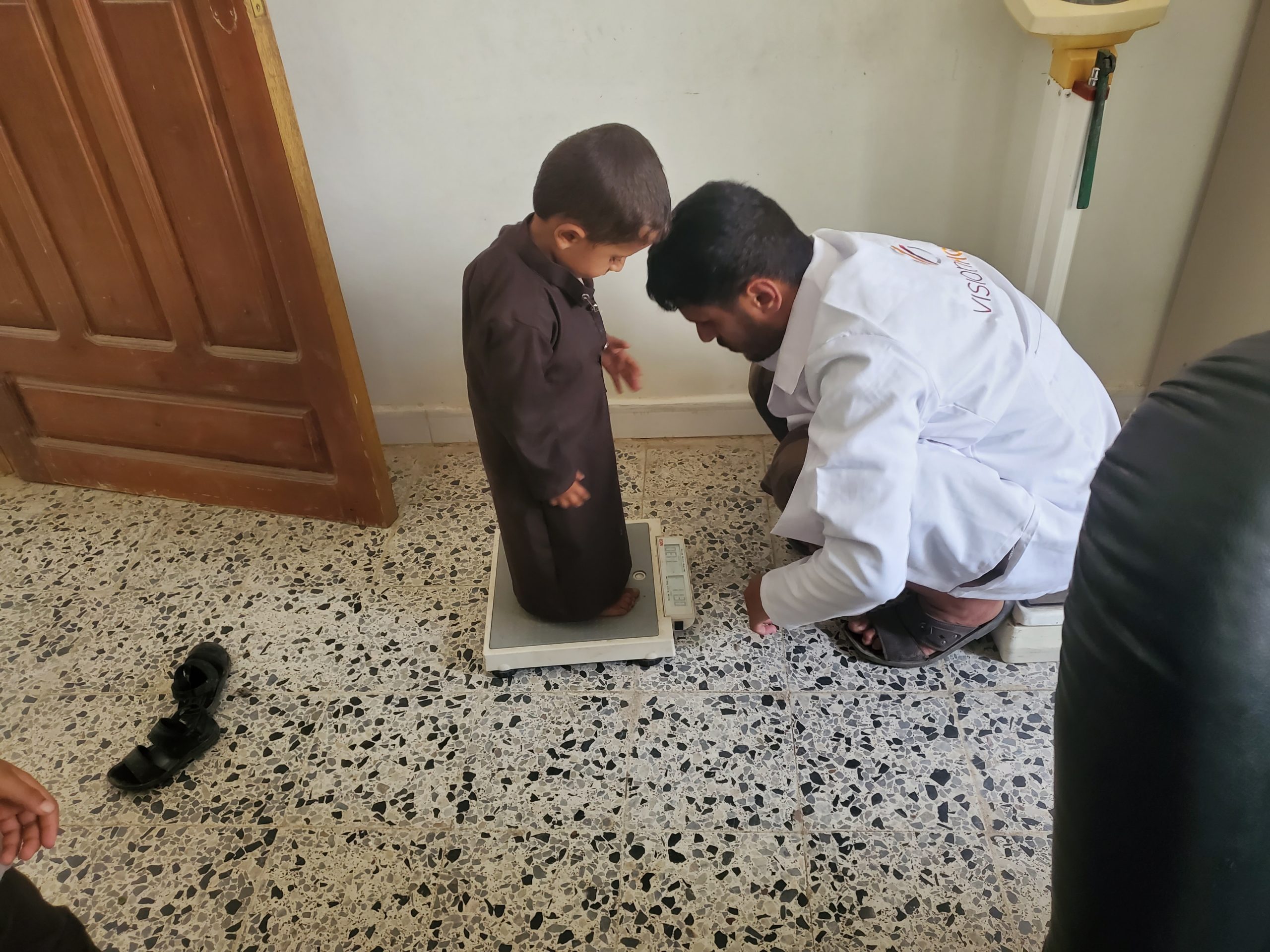 Nutrition Yemen A worker with a child