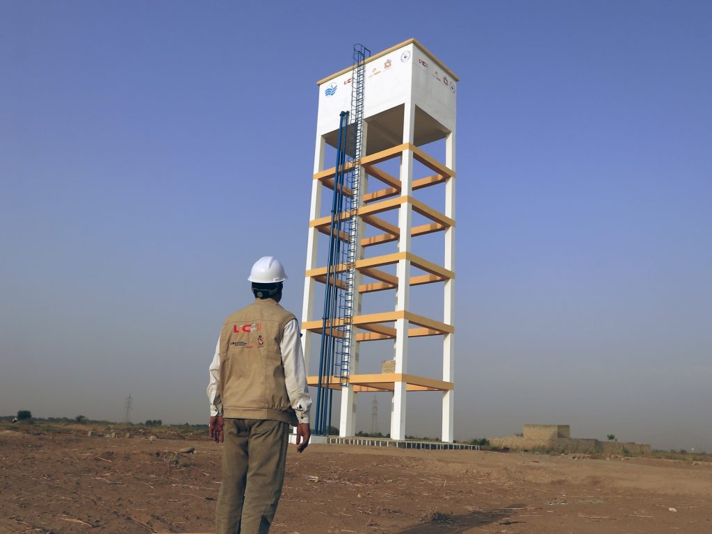 LDCP II staff member inspecting a newly built elevated water tank in Yemen