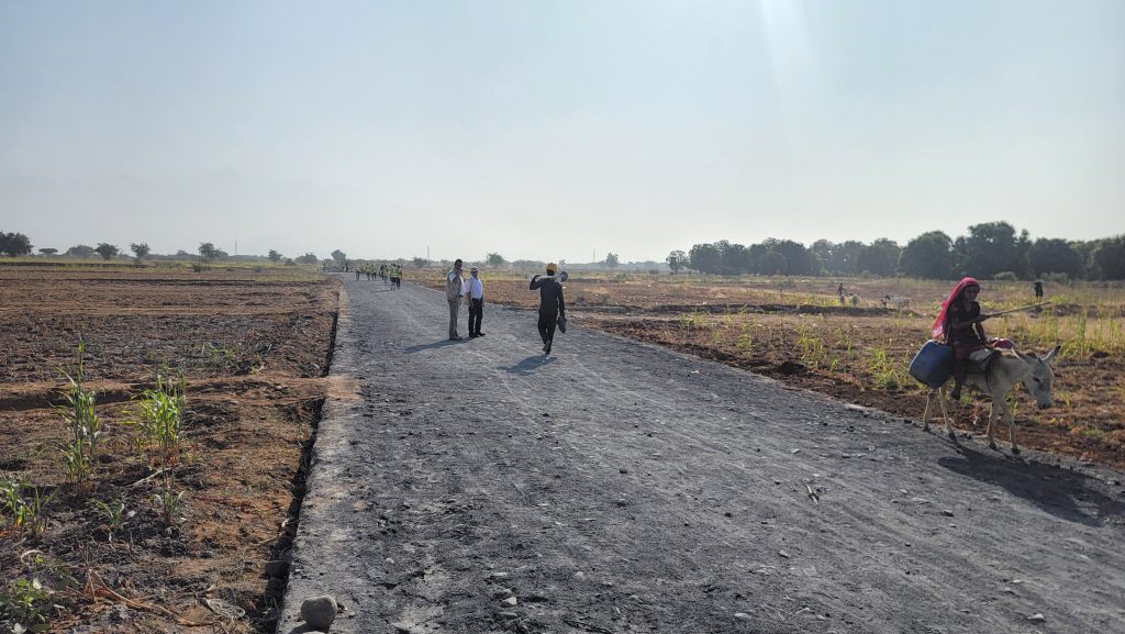 Workers and villagers walk along a rural road rebuilt through VHI's cash-for-work project in Al-Mighlaf, Yemen