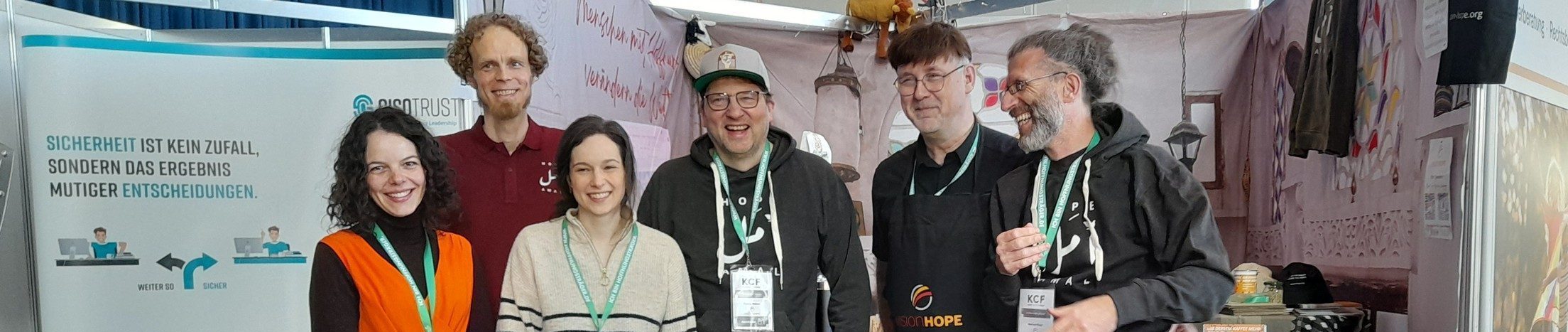 Vision Hope International team and corporate partners at their booth during the KCF 2025 conference in Germany