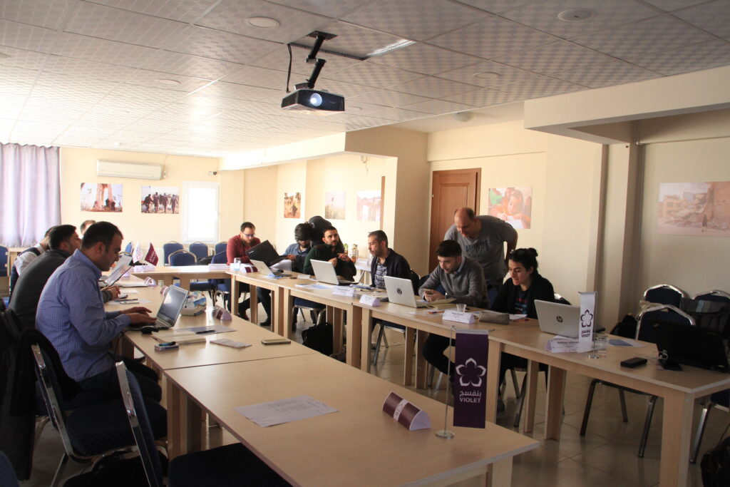 Team members reviewing project plans during a coordination meeting for Vision Hope's regional Syria program